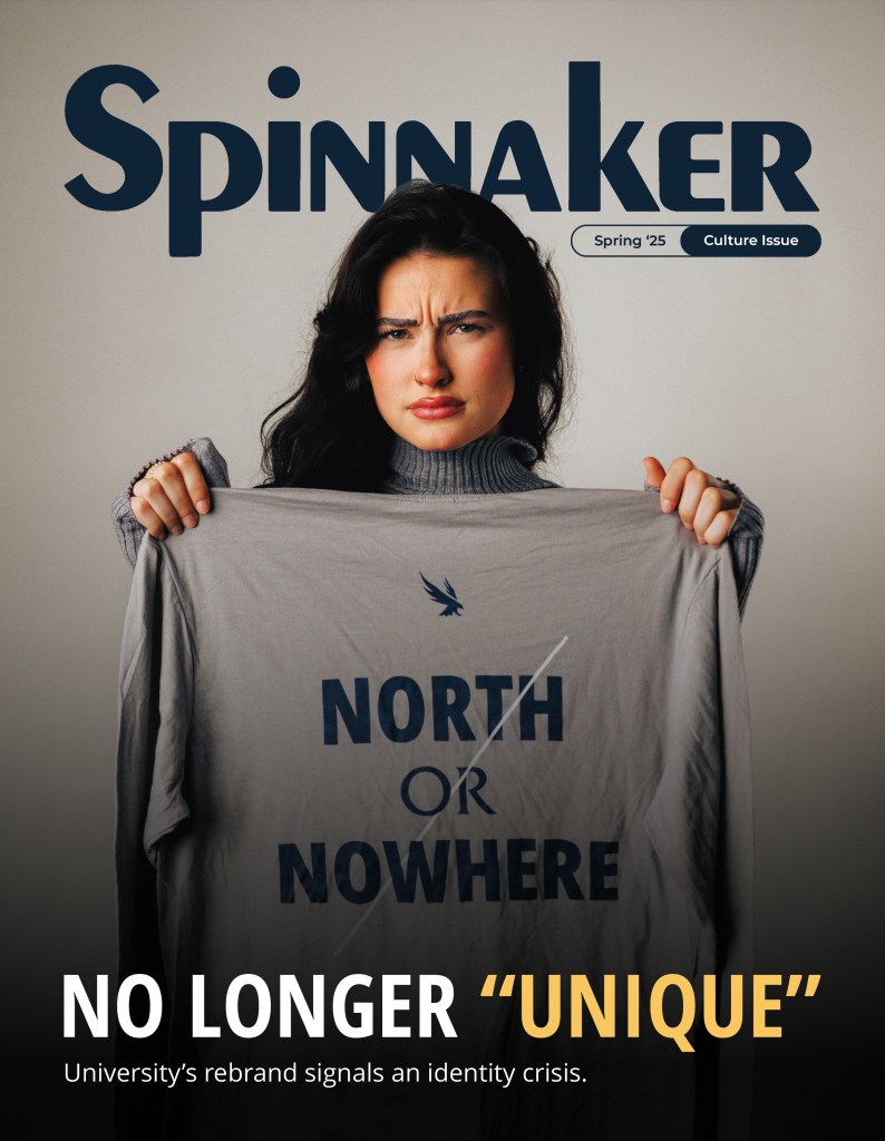 Spinnaker Magazine Spring '25 culture issue cover: a model holding up a gray shirt that says "North or Nowhere" with text overlayed reading "No Longer "Unique""