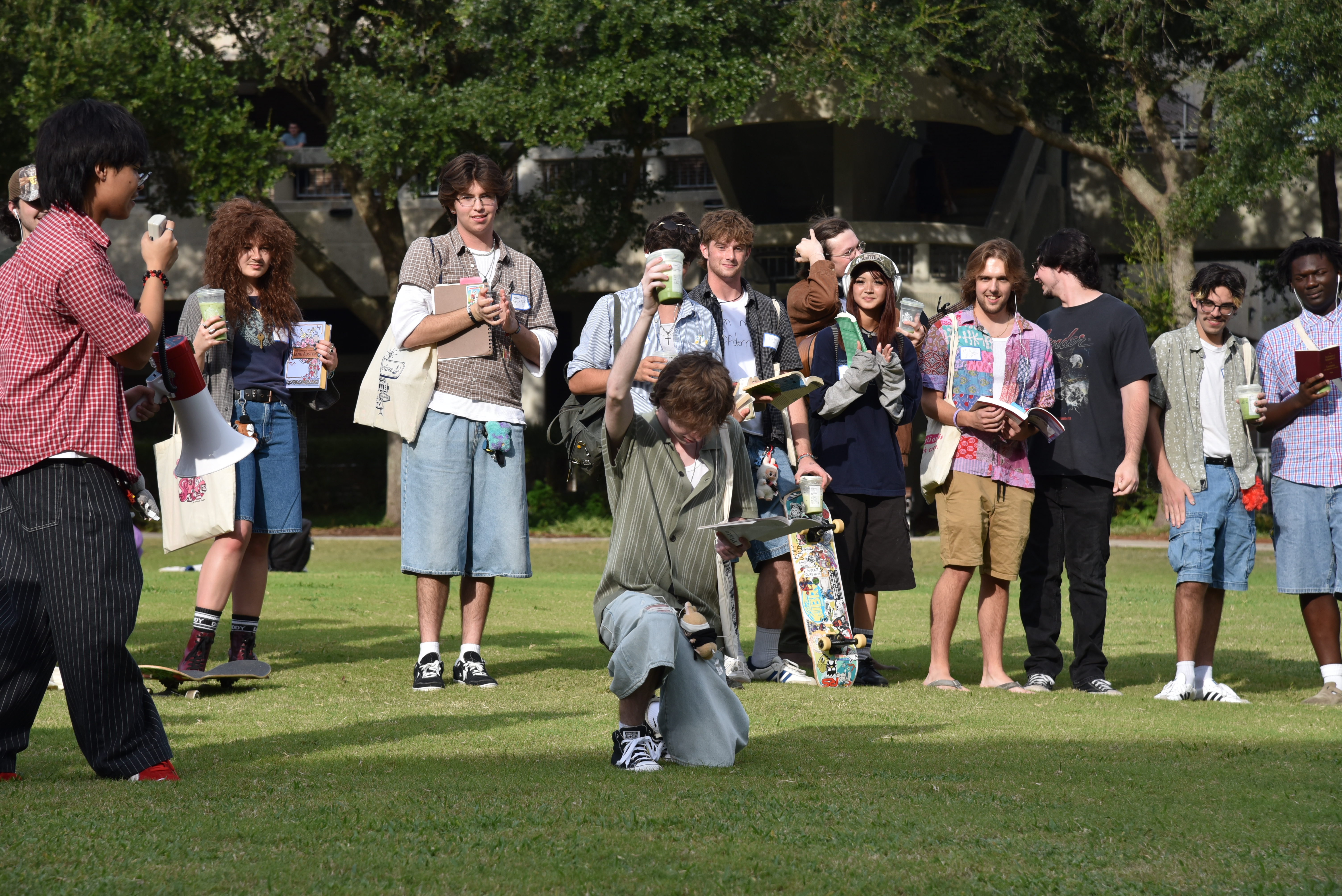 Students perform for a crowd wearing jorts, holding matcha lattes.