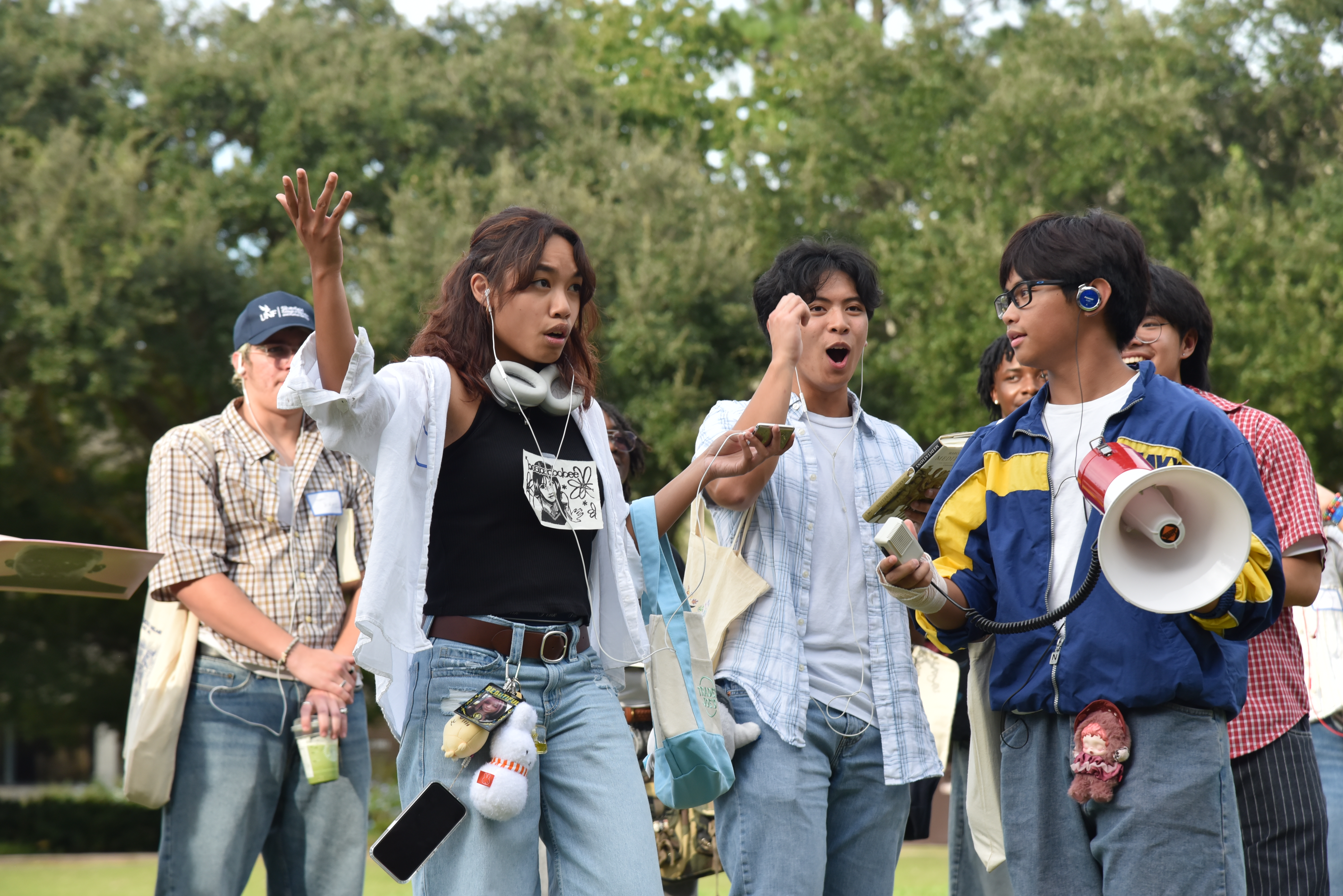 Students perform for a crowd wearing jorts, holding matcha lattes.