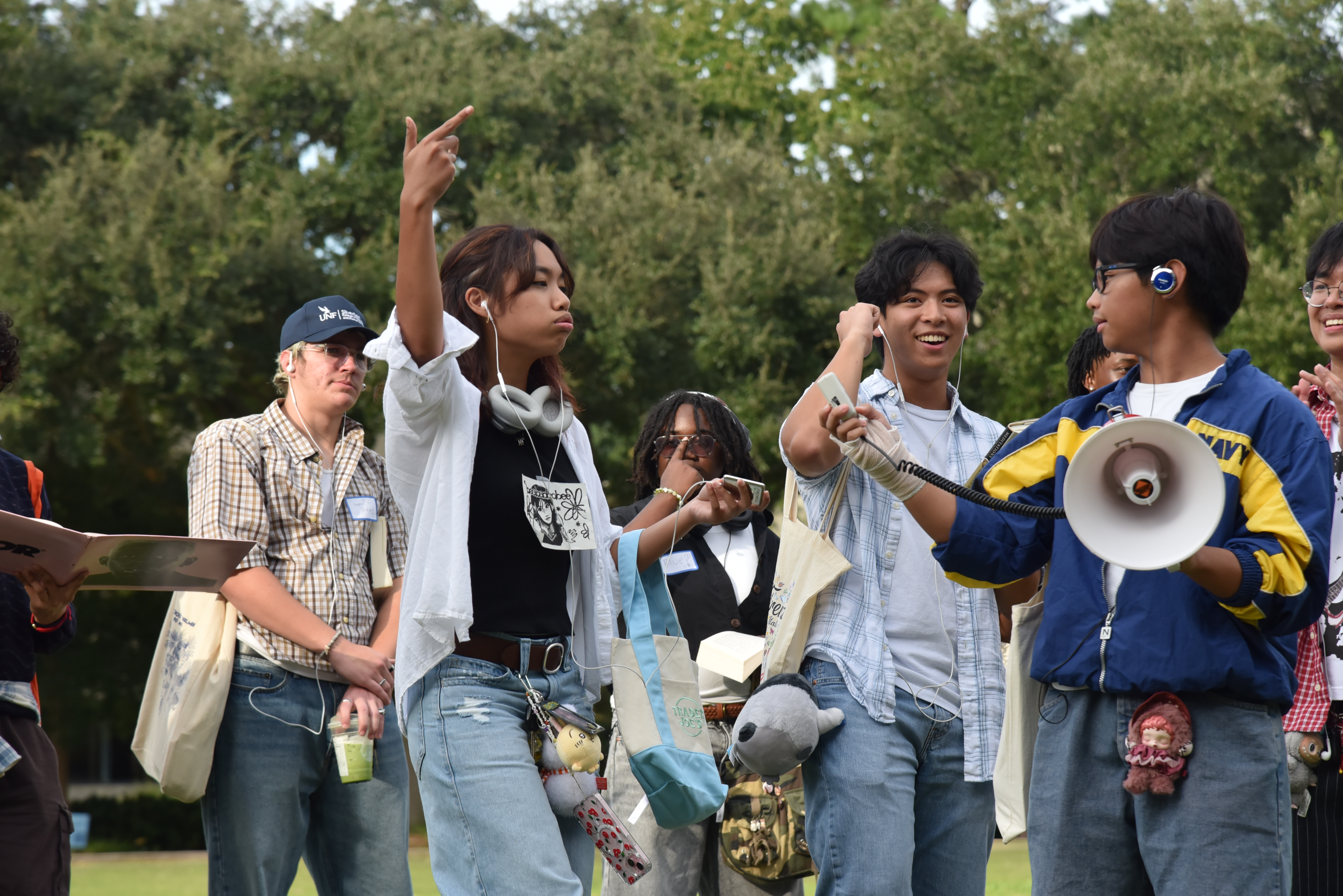 Students perform for a crowd wearing jorts, holding matcha lattes.