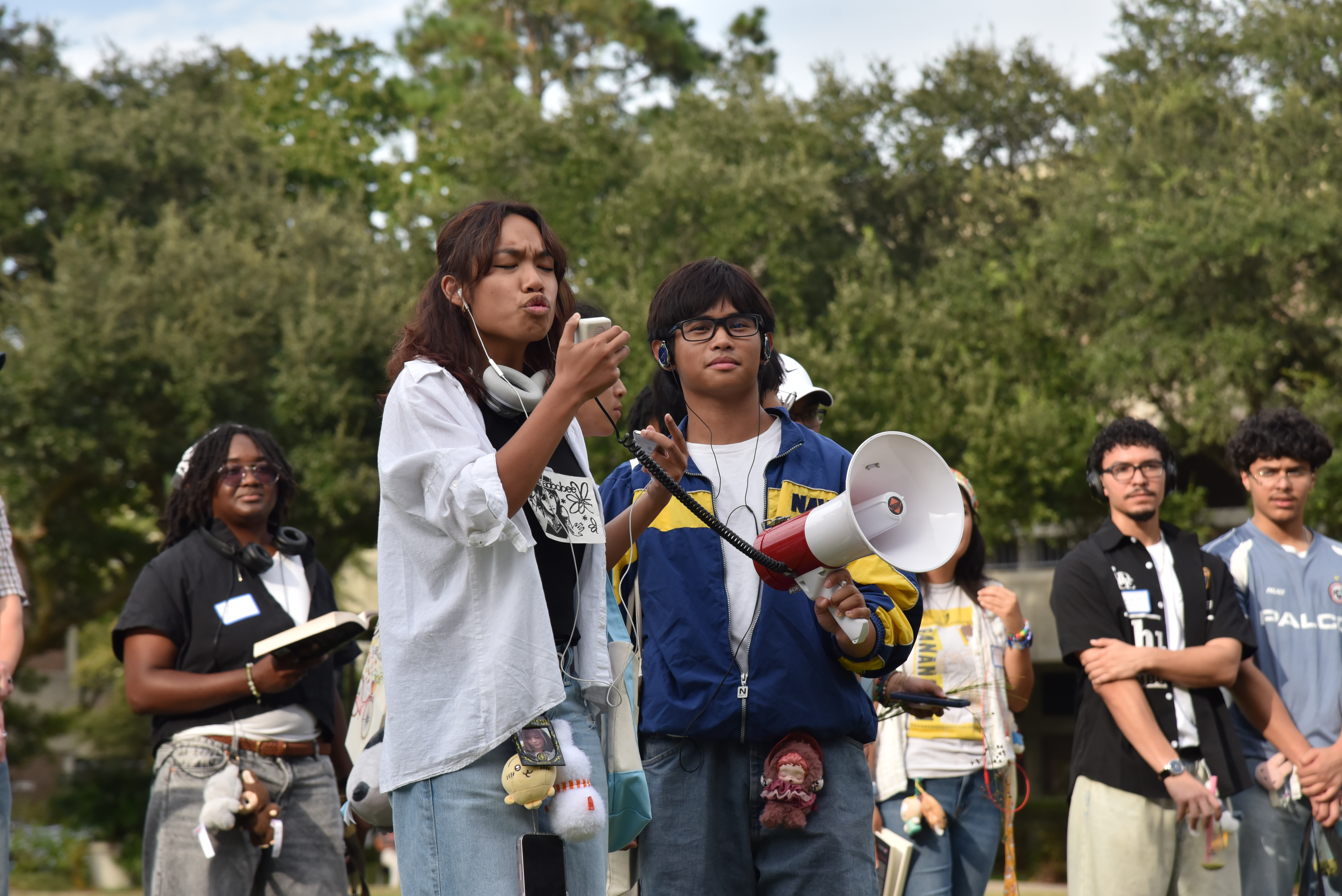Students perform for a crowd wearing jorts, holding matcha lattes.